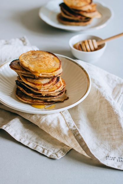 Premium Photo Banana Pancakes With Honey Honey Dipper On A White Background Morning Breakfast