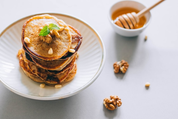 Banana Pancakes With Honey Honey Dipper On A White Background Premium Photo