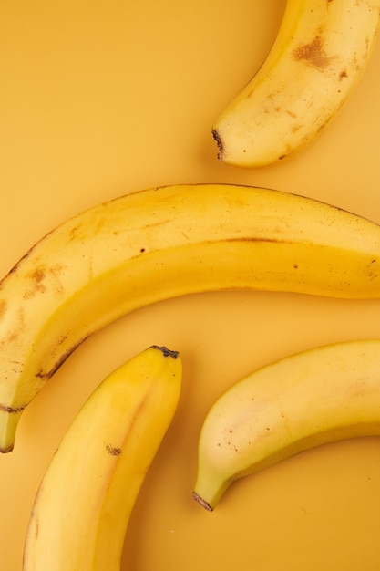 Premium Photo | Bananas yellow background with copy space