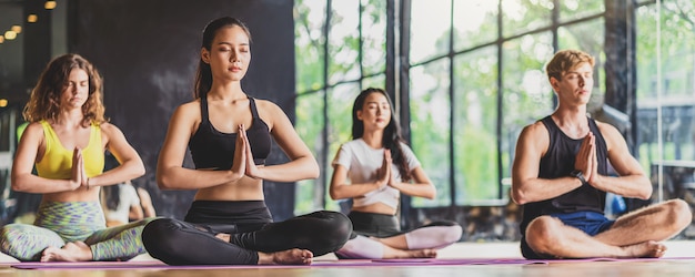 Banner, web page or cover template of group of diversity practicing yoga class Premium Photo