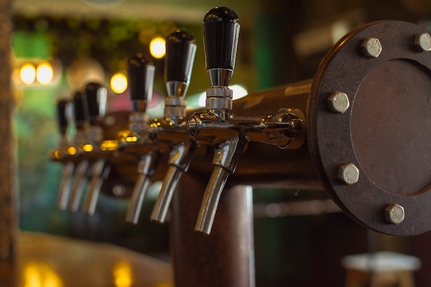 Bar set up to pour beer in mug Free Photo