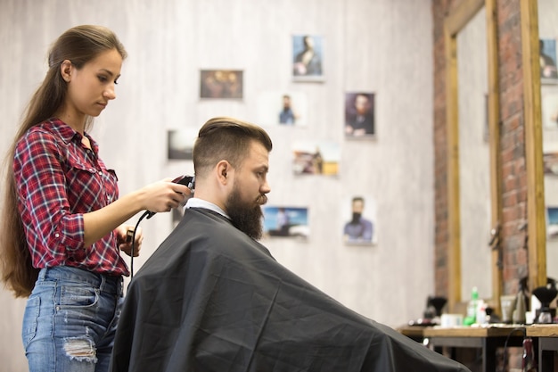 Free Photo | Barber woman serving client in barbershop