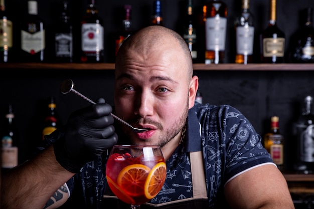 Premium Photo | Barman tasting fresh and tasty aperol cocktail