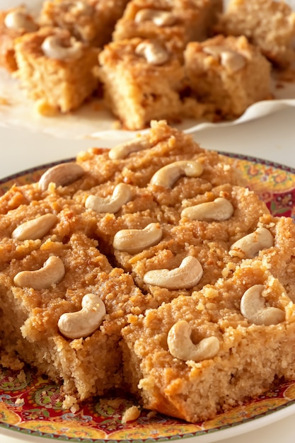 Premium Photo Basbousa Or Namoora Traditional Arabic Semolina Cake With Cashew Nuts And Syrup Selective Focus