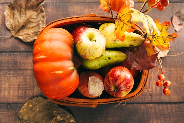 Free Photo | Basket with autumnal harvest on table