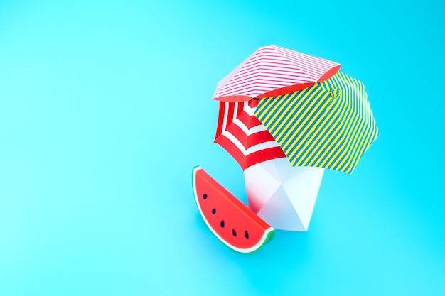 Beach Umbrella With Watermelon With Polygon Vase On Blue Photo