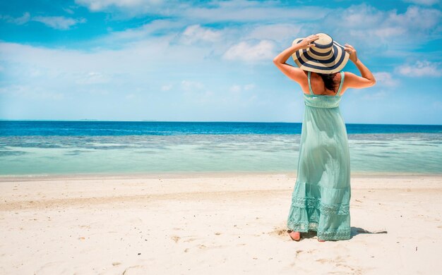 Premium Photo | Beach vacation. girl walking along a tropical beach in ...