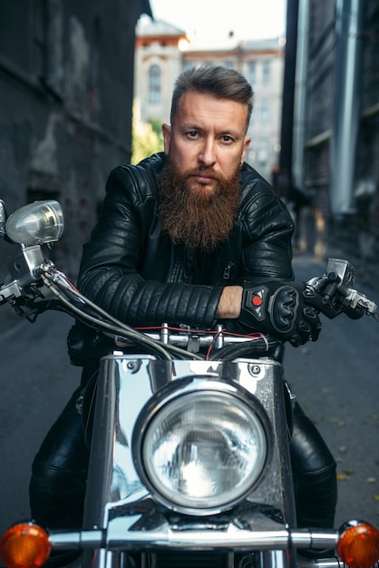 Premium Photo | Bearded biker on classical chopper