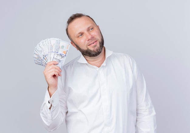 Free Photo Bearded Man Wearing White Shirt Holding Cash Looking Aside With Confident 5970