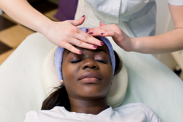 Premium Photo Beautiful African American Girl Having Facial Massage With Closed Eyes In Spa Salon