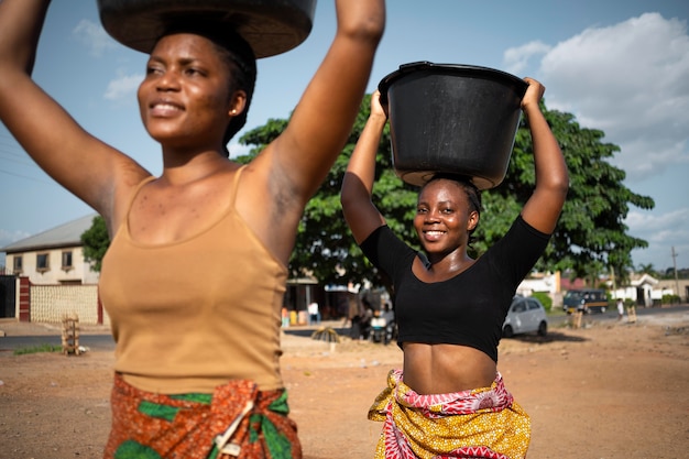 Free Photo | Beautiful african women fetching water from outdoors