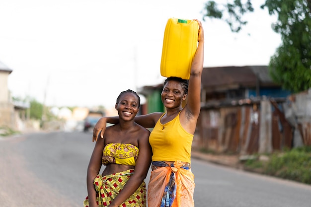 Premium Photo | Beautiful african women fetching water from outdoors