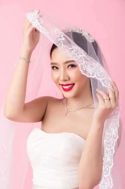 Beautiful asian bride portrait in pink studio Photo | Free Download