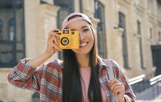 Premium Photo | Beautiful asian girl taking photo on retro camera