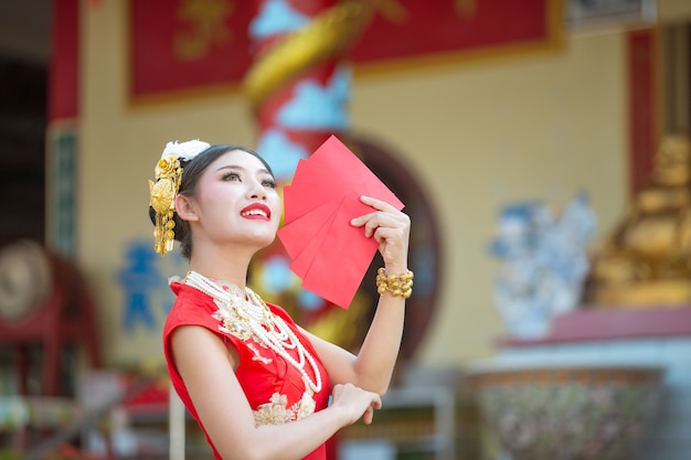 A beautiful asian girl wearing a red dress Free Photo