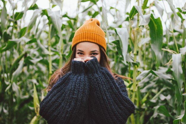 Premium Photo Beautiful Asian Girl Wearing Yellow Hat And Knitted Sweater In Autumn Corn Field