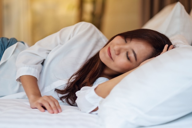 Premium Photo | A beautiful asian woman sleeping in a white cozy bed at home