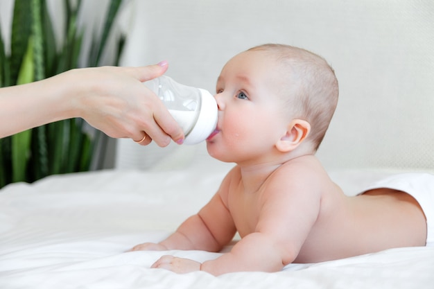 Premium Photo | Beautiful baby eating milk from bottle