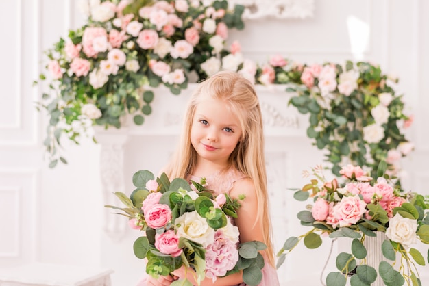 Premium Photo Beautiful Blonde Girl In A Soft Purple Dress On A Background Of Flowers Posing Cute Baby Model In The Image Of A Princess She S Wearing A Full Lilac Dress