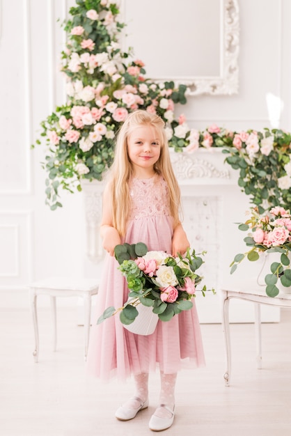 Premium Photo Beautiful Blonde Girl With Long Hair In A Soft Purple Dress On A Background Of Flowers Posing Cute Baby Model In The Image Of A Princess She S Wearing A