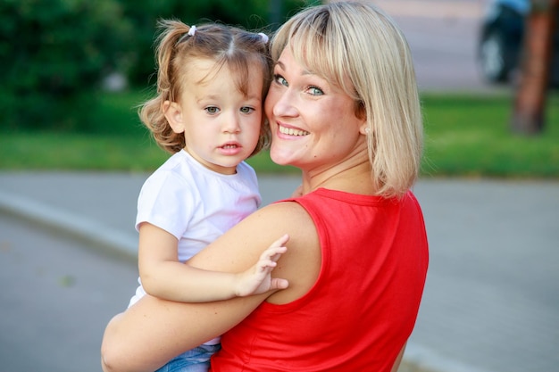 Premium Photo Beautiful Blonde Mom In A Red T Shirt With Her Daughter Group Portrait