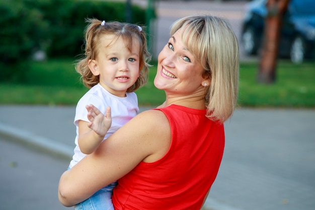 Premium Photo Beautiful Blonde Mom In A Red T Shirt With Her Daughter Group Portrait