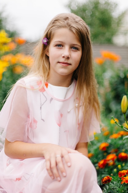 Premium Photo Beautiful Blue Eyed Girl With Long Blond Hair Little Girl In A Pink Flamingo Dress Girl In The Flower Garden Summer Bright Emotional Photo Large Thick Bright Flower Garden Near
