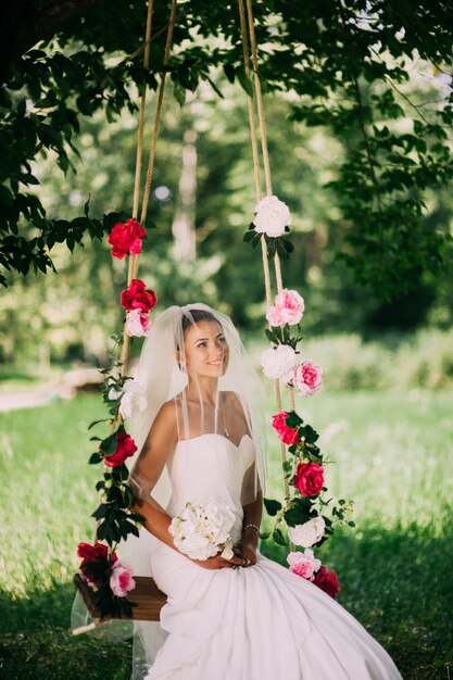 Premium Photo Beautiful Bride Swinging On A Swing 