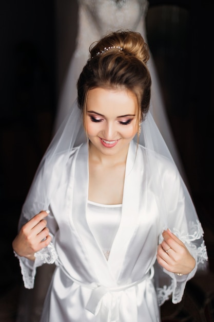 Premium Photo | Beautiful bride in white bathrobe with make up and ...