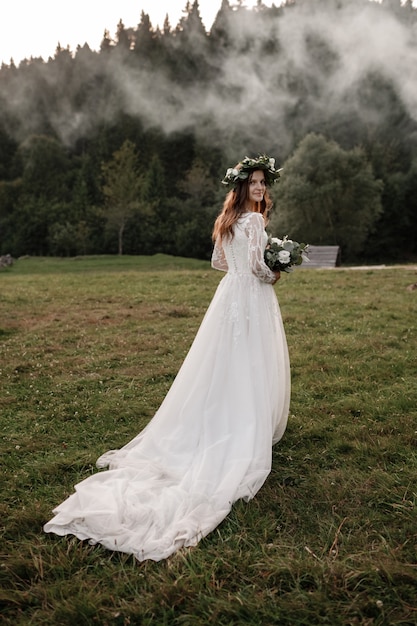 Premium Photo | Beautiful bride with a bouquet and a wreath on her head ...