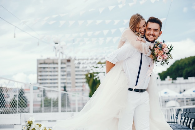 Beautiful bride with her husband in a park Free Photo
