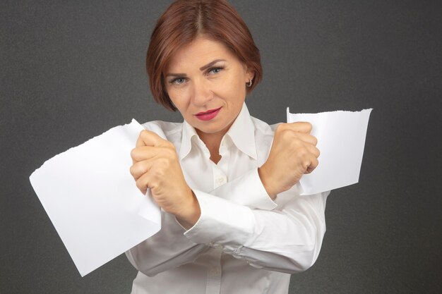 Premium Photo | Beautiful business woman tearing white paper in half