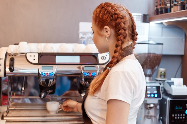 Free Photo | Beautiful caucasian lady smiling preparing hot coffee at