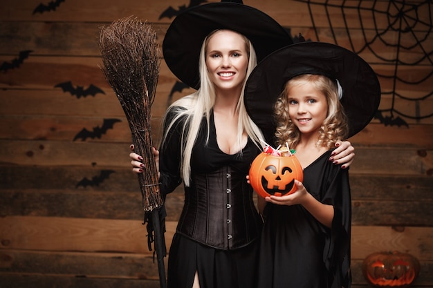 Beautiful Caucasian Mother And Her Daughter In Witch Costumes 