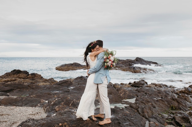 Beautiful couple having their wedding on the beach Free Photo