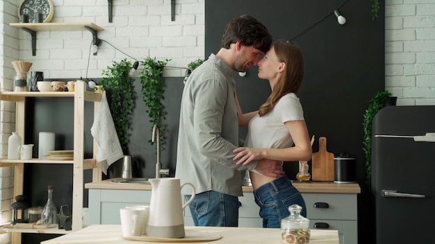 Premium Photo Beautiful Couple Hugging At The Kitchen In The Morning 