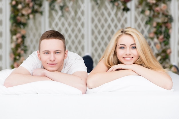 Premium Photo | Beautiful couple in love laying on the bed