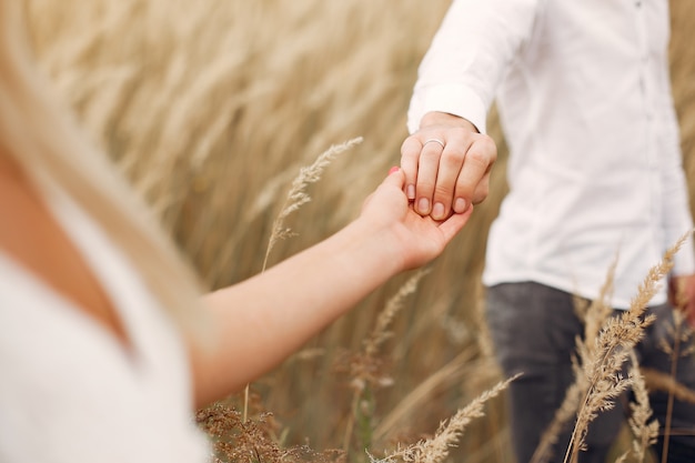 Beautiful couple spend time in a autumn field Free Photo