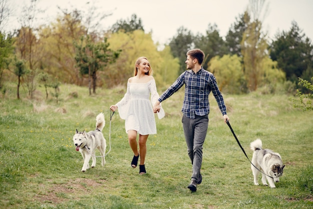 Beautiful couple in a summer forest with a dogs Free Photo