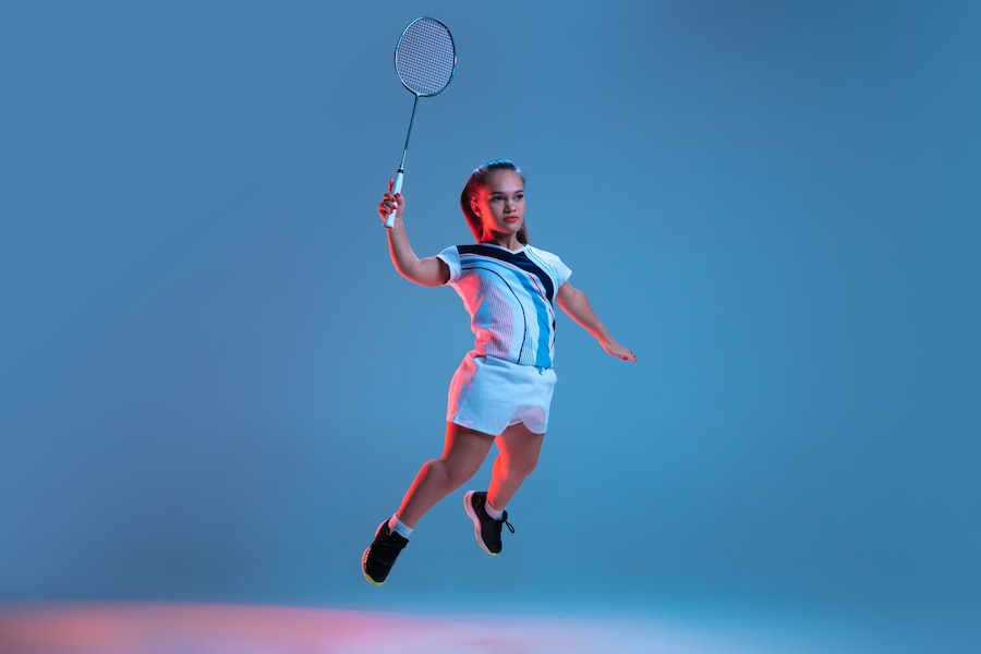 Free Photo Beautiful Dwarf Woman Practicing In Badminton Isolated On Blue In Neon Light