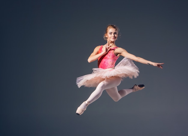 Beautiful Female Ballet Dancer On A Grey Background Ballerina Is Wearing Pink Tutu And Pointe 