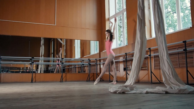 Premium Photo Beautiful Flexible Girl Warming Up At The Ballet Bar Circus Artist