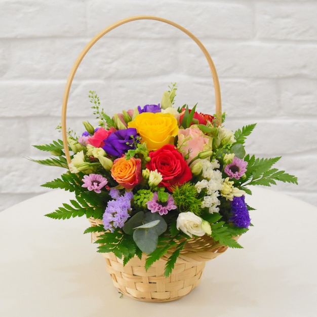 Premium Photo | Beautiful flower basket on a table