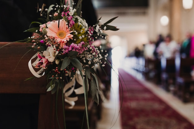 Premium Photo | Beautiful flower wedding decoration in a church. selective  focus. unrecognizable guests on background. marriage concept in church