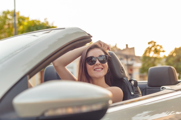 Premium Photo | Beautiful girl in the convertible cabrio car on a sunny ...