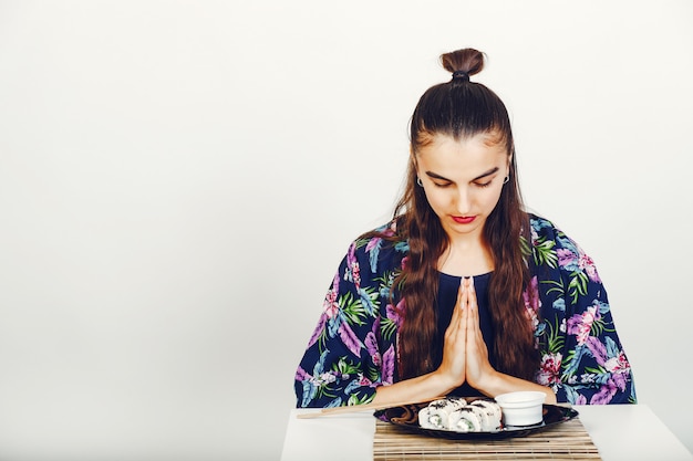 Beautiful Girl Eating A Sushi In A Studio Free Photo