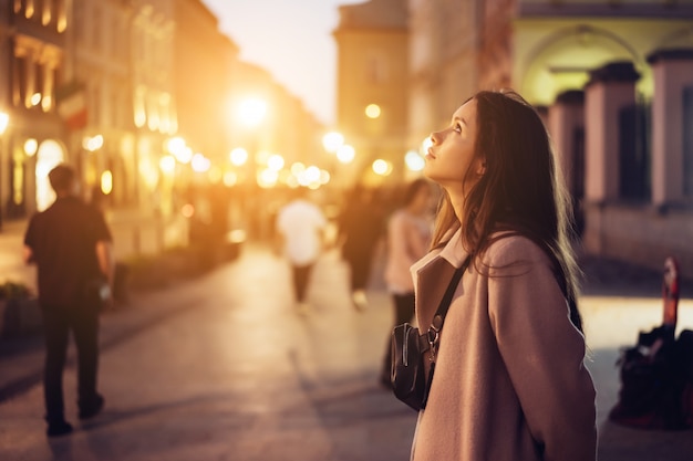 Beautiful girl in the evening on the street Free Photo
