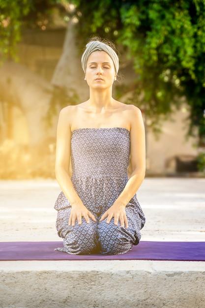 Premium Photo | Beautiful girl kneeling with closed eyes practicing ...