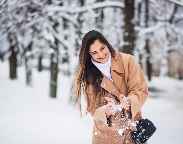 Free Photo | The beautiful girl playing with snow