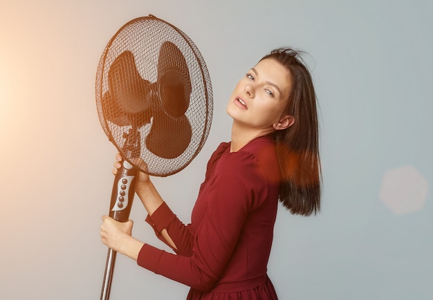 Premium Photo | Beautiful girl posing with a fan